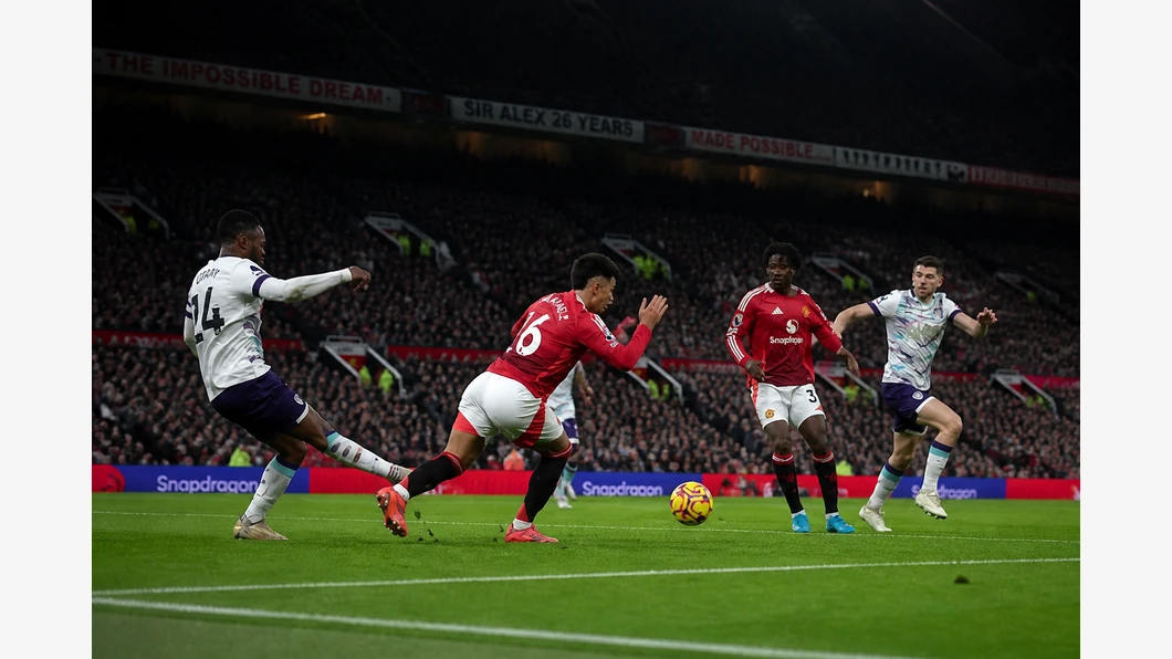 Rayan de Bournemouth et Bruno Fernandes de Manchester United se disputent un ballon près de leurs pieds devant des tribunes floutées.