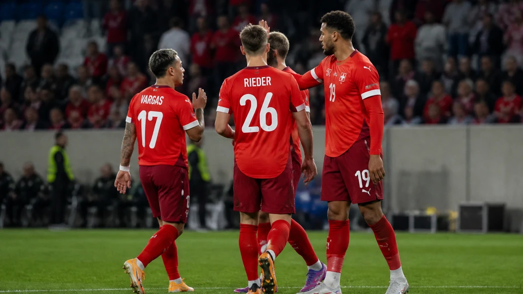 Joueurs suisses en rouge réunis sur le terrain, avec les tribunes en arrière-plan.